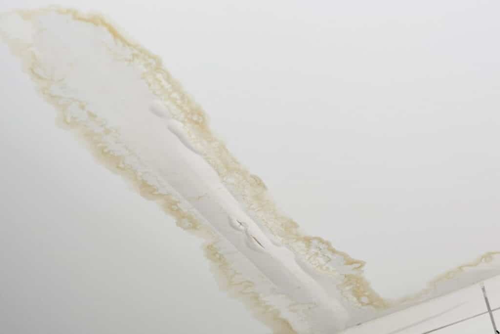 Water stains and ceiling damage caused by a roof leak