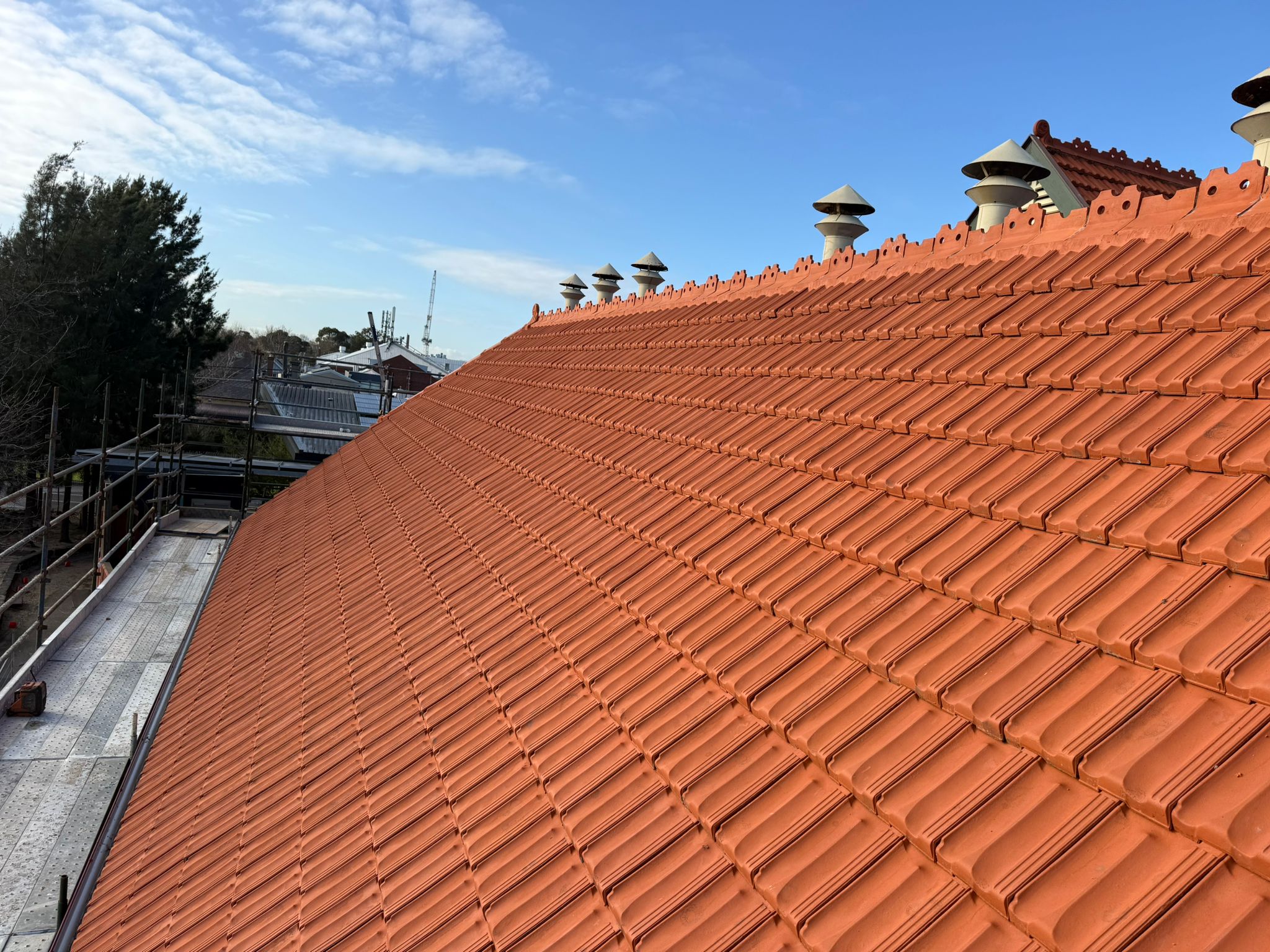 Close-up view of a stunning tile roof with evenly placed, high-quality tiles creating a sleek and elegant look.